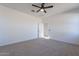 Spacious bedroom with neutral carpet and ceiling fan at 29282 W Clarendon Ave, Buckeye, AZ 85396