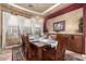 Elegant dining room with a chandelier and a large wooden table at 29411 N 123Rd Ln, Peoria, AZ 85383