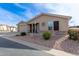 Tan house with a two-car garage and landscaped yard at 3301 S Goldfield Rd # 4094, Apache Junction, AZ 85119