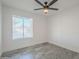 Simple bedroom with ceiling fan and tile floors at 3449 W Muriel Dr, Phoenix, AZ 85053