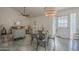 Dining area with a round table and metal chairs, adjacent to living room at 3449 W Muriel Dr, Phoenix, AZ 85053