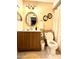 Clean bathroom with wooden vanity, round mirror, and shower/tub combo at 404 E Paseo De Isabella --, Casa Grande, AZ 85122