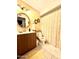 Clean bathroom with wooden vanity, round mirror, and shower/tub combo at 404 E Paseo De Isabella --, Casa Grande, AZ 85122