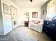 Bedroom sitting area with loveseat, end table, and religious decor at 404 E Paseo De Isabella --, Casa Grande, AZ 85122
