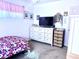 A bedroom with white furniture, floral bedding, and personal decor at 404 E Paseo De Isabella --, Casa Grande, AZ 85122