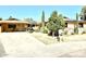 Front view of a charming home with solar panels and a well-maintained yard at 404 E Paseo De Isabella --, Casa Grande, AZ 85122