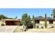 Ranch style home with solar panels, mature landscaping, and a paved driveway at 404 E Paseo De Isabella --, Casa Grande, AZ 85122