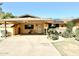 House exterior with covered carport, mature landscaping and stone accents at 404 E Paseo De Isabella --, Casa Grande, AZ 85122