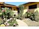 Landscaped front yard with walkway, beautiful rose bushes, and stone accents at 404 E Paseo De Isabella --, Casa Grande, AZ 85122