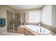 Bathroom with a walk-in shower and a corner soaking tub at 4582 S Wildflower Pl, Chandler, AZ 85248