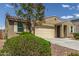 Tan house exterior with a two-car garage and manicured landscaping at 7262 E Mallard Ct, San Tan Valley, AZ 85143