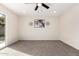 Bedroom with carpet, ceiling fan and sliding glass doors to backyard at 7309 W Claremont St, Glendale, AZ 85303