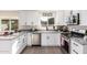 Modern kitchen with white shaker cabinets, granite counters, and stainless steel appliances at 7309 W Claremont St, Glendale, AZ 85303