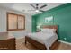 Bedroom with green accent wall and wood bed frame at 819 W Sparrow Pl, Chandler, AZ 85286