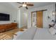 Main bedroom with a barn door to the bathroom and a dresser at 819 W Sparrow Pl, Chandler, AZ 85286