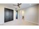 Bedroom with ceiling fan, double doors to closet and en-suite bathroom at 9669 E Chino E Dr, Scottsdale, AZ 85255