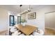 Elegant dining room with a large wood table and white chairs, featuring hardwood floors at 9669 E Chino E Dr, Scottsdale, AZ 85255