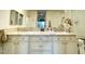 Modern bathroom with dual sinks, granite countertops, and ample cabinet space at 10063 E Cinnabar Ave, Scottsdale, AZ 85258