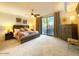 Spacious bedroom with a king-size bed, access to a private patio, and plenty of natural light at 10063 E Cinnabar Ave, Scottsdale, AZ 85258