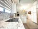 Modern kitchen with granite countertops, stainless steel sink, and white cabinetry at 10063 E Cinnabar Ave, Scottsdale, AZ 85258