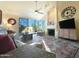 Spacious living room with fireplace and sliding glass doors at 10063 E Cinnabar Ave, Scottsdale, AZ 85258