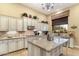 Gourmet kitchen with granite countertops, custom cabinetry, and island at 10737 E Scopa Trl, Scottsdale, AZ 85262