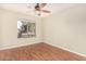 Simple bedroom with wood-look floors and a window at 12549 W Woodland Ave, Avondale, AZ 85323