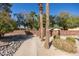 Community entrance with palm trees and brick wall at 13324 W Stonebrook Dr, Sun City West, AZ 85375