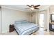 Bright bedroom with a ceiling fan and access to a private balcony at 1401 E Puget Ave # 24, Phoenix, AZ 85020