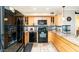 Modern kitchen with black appliances and wood cabinets at 1401 E Puget Ave # 24, Phoenix, AZ 85020