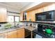 Bright kitchen features granite countertops and black appliances at 1401 E Puget Ave # 24, Phoenix, AZ 85020