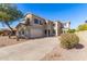 Two-story house with a three-car garage and desert landscaping at 1430 E Douglas St, Casa Grande, AZ 85122