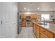 Spacious kitchen with island, stainless steel appliances, and light wood cabinets at 17655 W Acapulco Ln, Surprise, AZ 85388