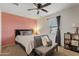 Cozy bedroom with a queen bed and a pink accent wall at 1805 E Grenadine Rd, Phoenix, AZ 85040