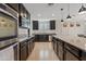 Modern kitchen with dark cabinetry, granite countertops, and stainless steel appliances at 1805 E Grenadine Rd, Phoenix, AZ 85040