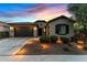 Attractive home with landscaping and lighting at dusk at 20539 W Rosewood Ln, Buckeye, AZ 85396