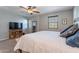 Bright bedroom with ceiling fan and neutral wall colors at 29381 N 123Rd Ave, Peoria, AZ 85383