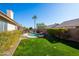 Landscaped backyard oasis with pool, grass, and seating area at 4113 W Bart Dr, Chandler, AZ 85226