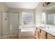 Clean bathroom with a bathtub, shower, and a block glass window at 4113 W Bart Dr, Chandler, AZ 85226