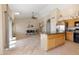 Spacious kitchen with an island, stainless steel appliances, and light tile flooring at 4113 W Bart Dr, Chandler, AZ 85226