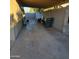 Small backyard with covered patio, showing a gravel area and a trash bin at 4115 N 18Th Dr, Phoenix, AZ 85015