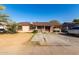 House exterior featuring a large yard and driveway at 6230 W Berkeley Rd, Phoenix, AZ 85035