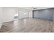 Bright living room with gray accent wall and sliding glass doors at 6526 W Devonshire Ave, Phoenix, AZ 85033