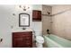 Clean bathroom with tub, toilet and wood vanity at 6816 E Oak St, Scottsdale, AZ 85257