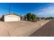 Front view of a single-story home with a spacious driveway at 6816 E Oak St, Scottsdale, AZ 85257