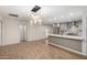 Modern kitchen with gray cabinets, quartz countertops, and an island at 6816 E Oak St, Scottsdale, AZ 85257