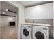 Laundry room with washer, dryer, and additional storage at 6816 E Oak St, Scottsdale, AZ 85257