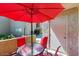 Private patio with red umbrella and seating for four at 7430 E Chaparral Rd # A129, Scottsdale, AZ 85250