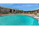 Inviting community pool with surrounding patio and building views at 7430 E Chaparral Rd # A129, Scottsdale, AZ 85250