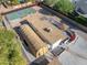 Aerial view of a large lot with a house, garage, and basketball court at 8340 E Thomas Rd, Scottsdale, AZ 85251
